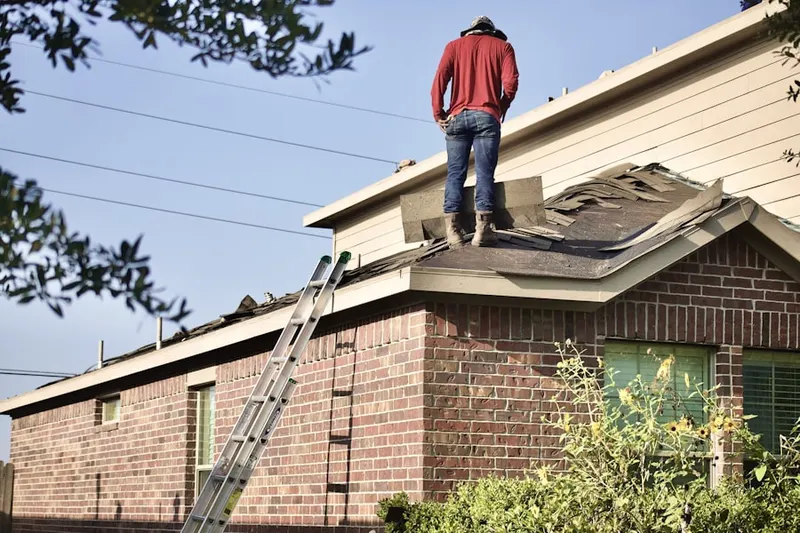 Professional roofer working on a residential roof in Hampton Woods